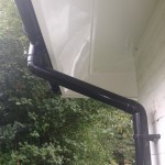 White Angled Soffit With Black Round Pipe